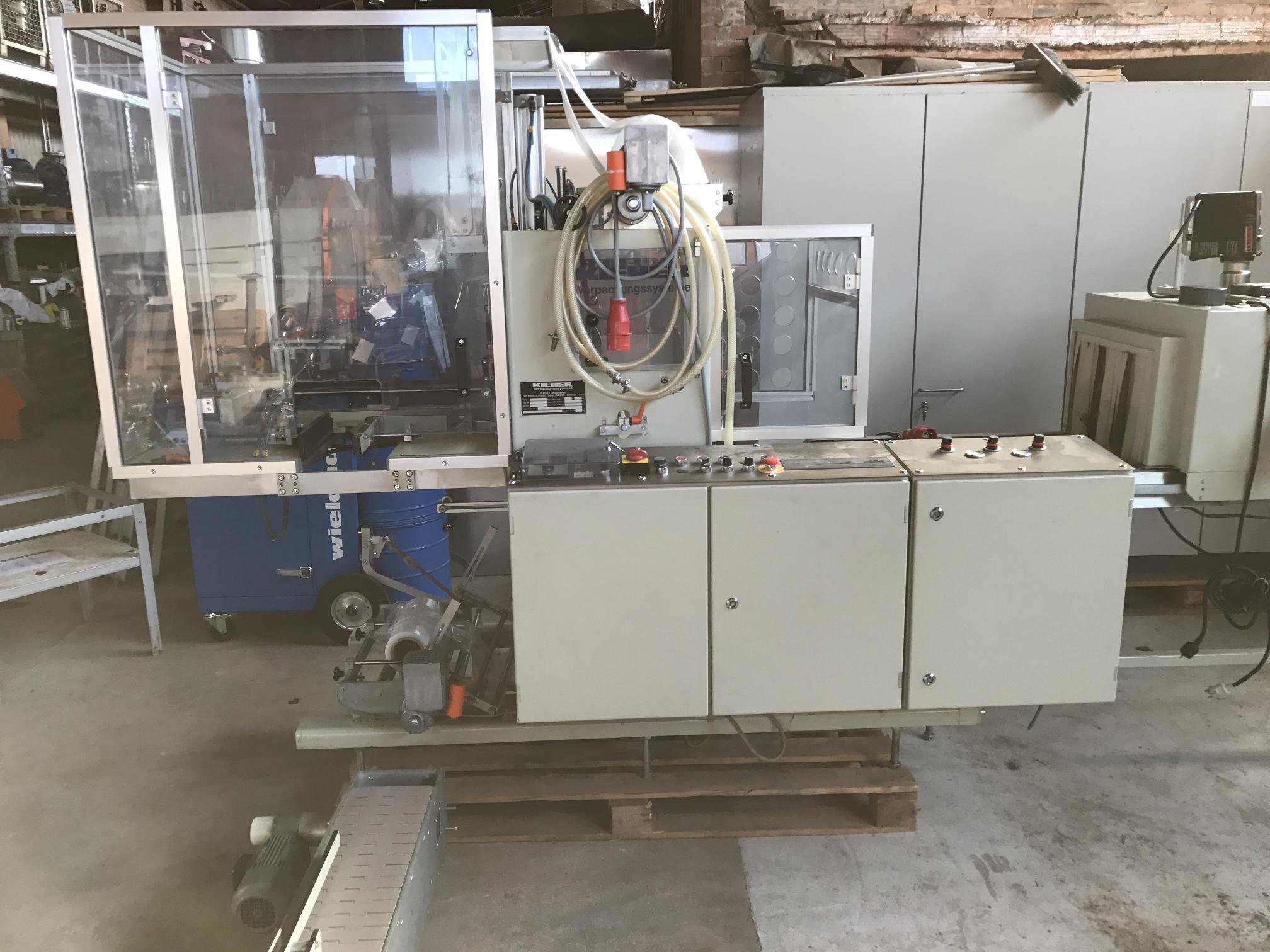 Tensile band eroration machine with shrink tunnel